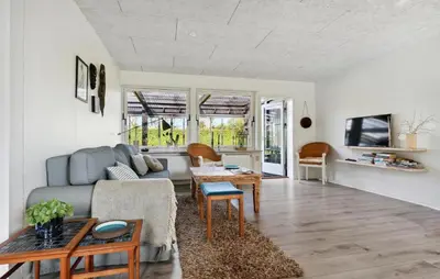 a living room with a couch and a table at Awesome Home In Nykøbing M in Hesselbjerg