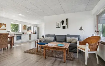 a living room with a couch and a table at Awesome Home In Nykøbing M in Hesselbjerg
