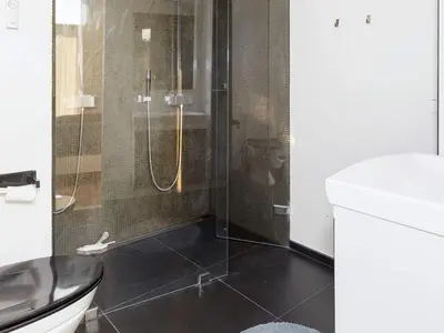 a bathroom with a shower with a toilet and a sink at 4 star holiday home in Skals-By Traum in Skals