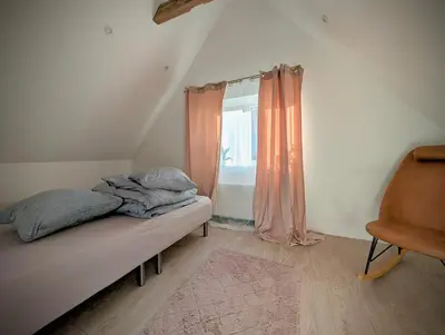 a small bedroom with a bed and a window at Villa Vandkant in Thyholm