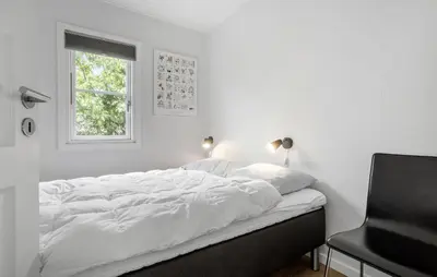 a white bedroom with a bed and a window at Stunning Home In Vestervig With Kitchen in Vestervig