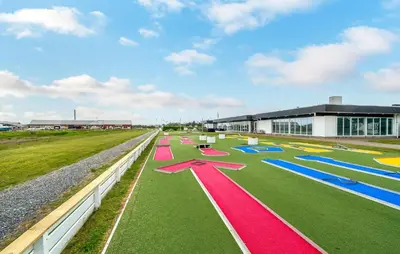 a row of colorful mats on a field in front of a building at Stunning Home In Vestervig With Kitchen in Vestervig