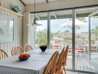 a dining room with a table with a bowl of fruit on it at Holiday Home Floria - 1-4km from the sea by Interhome in Torsted