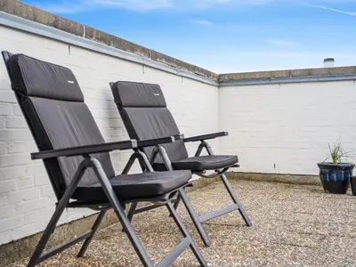 two black chairs sitting next to a wall at Holiday Home Werna - 900m from the sea by Interhome in Pandrup