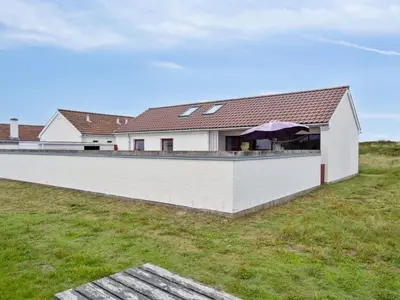 a white house with a white wall at Holiday Home Werna - 900m from the sea by Interhome in Pandrup