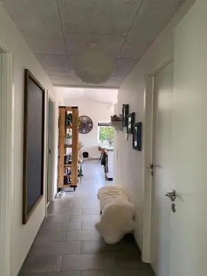 a hallway with a room with a couch on the floor at Hyggeligt hus. in Holstebro