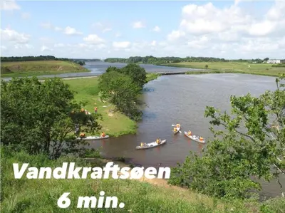 a group of people in boats on a river at Hyggeligt hus. in Holstebro