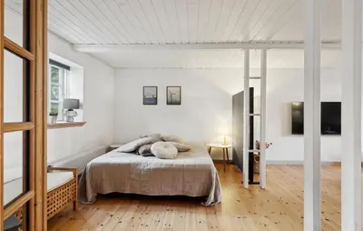 a bedroom with a bed in a white room at 3 Bedroom Cozy Home In Løgstrup in Knud