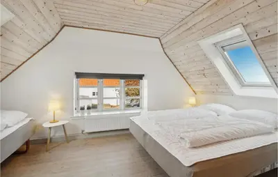 a white bedroom with a large bed and a window at 3 Bedroom Cozy Home In Løgstrup in Knud
