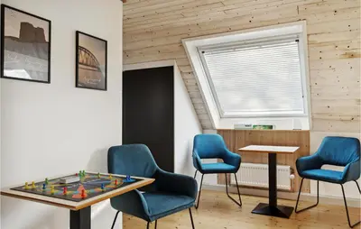a room with chairs and a table with a chessboard at 3 Bedroom Cozy Home In Løgstrup in Knud