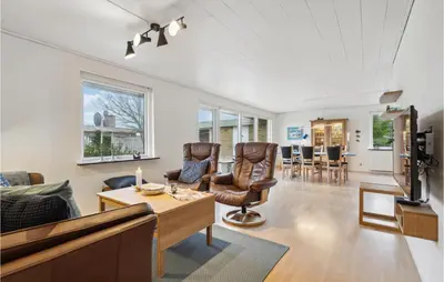 a living room with a couch and a table at 3 Bedroom Lovely Home In Vestervig in Vestervig
