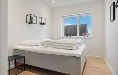 a white room with a bed and a window at Awesome Home In Thisted With Sauna in Thisted