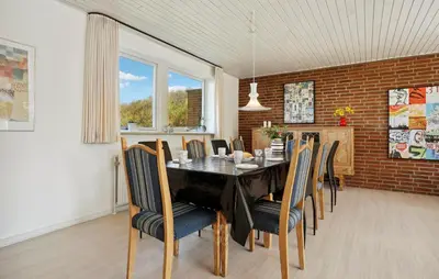 a dining room with a table and chairs at Beautiful Home In Nykøbing M With Wifi in Nykøbing Mors