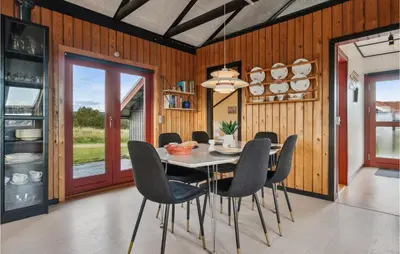 a dining room with a table and chairs at Nice Home In Harboøre With Wifi in Harboør