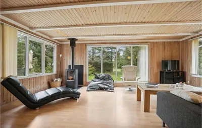 a living room with a couch and a table at Nice Home In Thyholm With Wifi in Thyholm