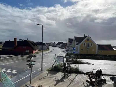 an empty street with houses and a street light at Stor lejlighed ved stranden i Agger Cold Hawaii in Agger