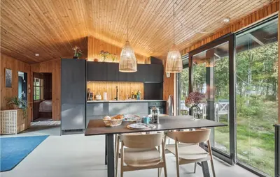 a kitchen with a table and chairs in a house at 2 Bedroom Gorgeous Home In Højslev in Højslev