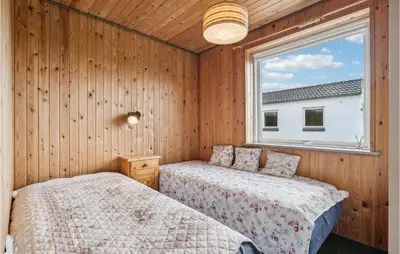 two beds in a room with a window at 3 Bedroom Beautiful Home In Spøttrup in Spottrup