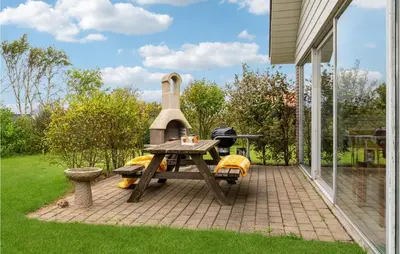 a patio with a picnic table and a grill at 3 Bedroom Beautiful Home In Spøttrup in Spottrup