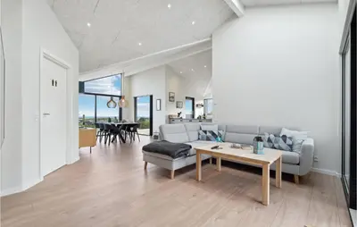 a living room with a couch and a table at Cozy Home In Lemvig With House Sea View in Lemvig