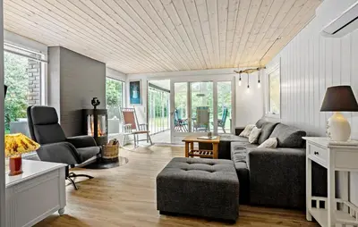 a living room with a gray couch and chairs at 3 Bedroom Nice Home In Thyholm in Thyholm
