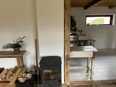 a kitchen with a wood stove in a room at The Beach Farm - charm, beach and stunning nature in Bedsted Thy
