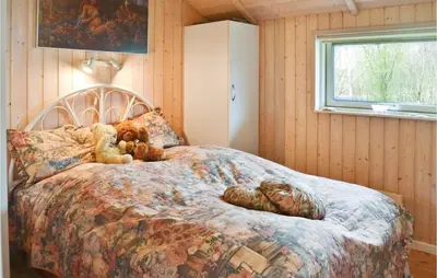 a bedroom with a bed with teddy bears on it at Nice Home In Vinderup With Kitchen in Vinderup