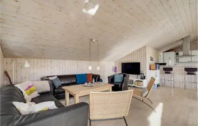 a living room with a couch and a table at Holiday Home Højslev 42 in Højslev