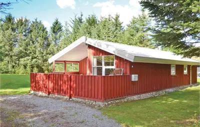 a red house with a red fence around it at Holiday Home Blokhus 9 in Blokhus