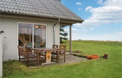 a table and chairs sitting outside of a house at 3 Bedroom Amazing Home In Højslev in Højslev