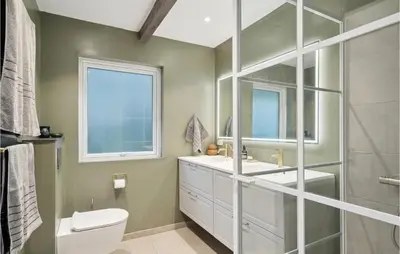 a bathroom with a toilet and a sink and a window at 3 Bedroom Amazing Home In Højslev in Højslev