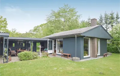 a house with a patio and a yard at Holiday Home Farsø 49 in Farsø