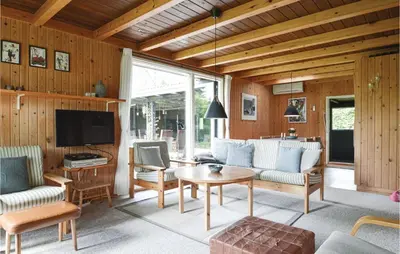 a living room with a couch and a table at Holiday Home Farsø 49 in Farsø