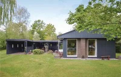 a black house with a brick at Holiday Home Farsø 49 in Farsø