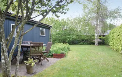 a backyard with a table and chairs and a shed at Holiday Home Farsø 49 in Farsø