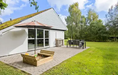 a patio with an umbrella and a table and chairs at Amazing Home In Farsø With Wifi in Farsø