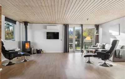 a living room with chairs and a couch and a tv at Amazing Home In Farsø With Wifi in Farsø
