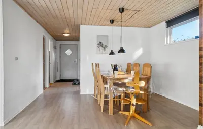 a dining room and kitchen with a table and chairs at Amazing Home In Farsø With Wifi in Farsø