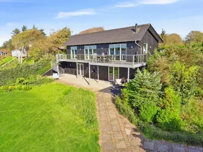 an aerial view of a house with a green yard at Holiday Home Berta - 70m to the fjord by Interhome in Roslev