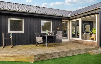 a deck with a table and chairs on it at Cozy Home In Struer With Wifi in Struer