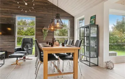 a dining room with a wooden table and chairs at Cozy Home In Struer With Wifi in Struer