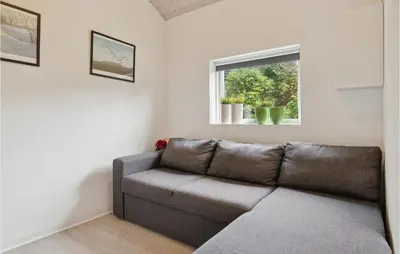 a living room with a couch and a window at Cozy Home In Struer With Wifi in Struer