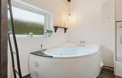 a bath tub in a bathroom with a window at Cozy Home In Struer With Wifi in Struer