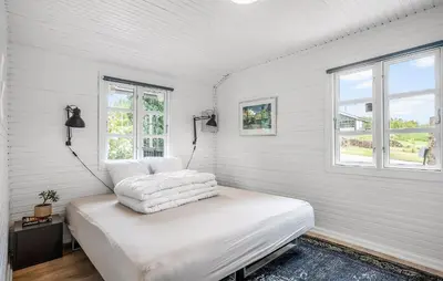 a white room with a bed with two pillows on it at Cozy Home In Løgstrup With Wifi in Løgstrup