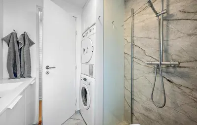 a bathroom with a shower and a washing machine at Cozy Home In Løgstrup With Wifi in Løgstrup