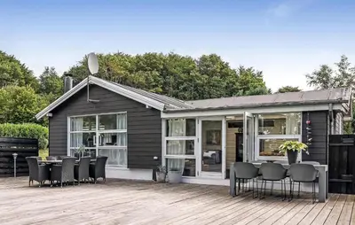 a house with chairs and a table on a deck at Cozy Home In Løgstrup With Wifi in Løgstrup