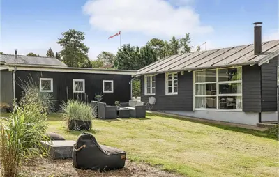 a house with a yard in front of it at Cozy Home In Løgstrup With Wifi in Løgstrup