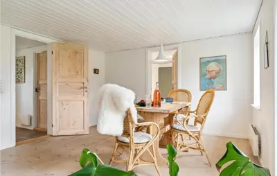 a dining room with a wooden table and chairs at 2 Bedroom Cozy Home In Fjerritslev in Fjerritslev