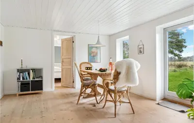 a dining room with a table and chairs at 2 Bedroom Cozy Home In Fjerritslev in Fjerritslev