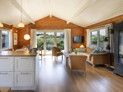 a kitchen and living room with a couch and a table at Holiday Home Efra - 400m from the sea by Interhome in Saltum